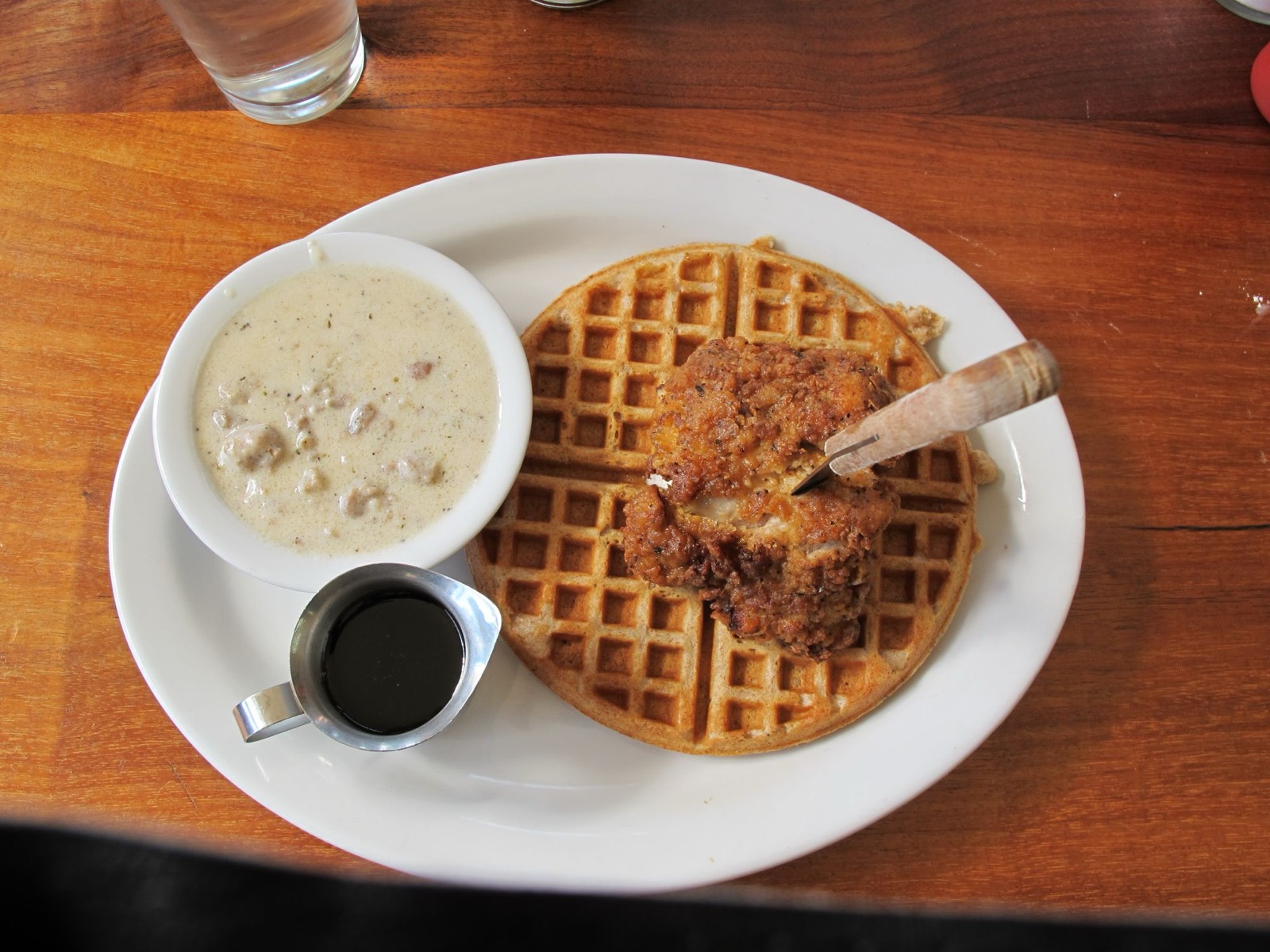 Fried chicken and waffle with country gravy and syrup