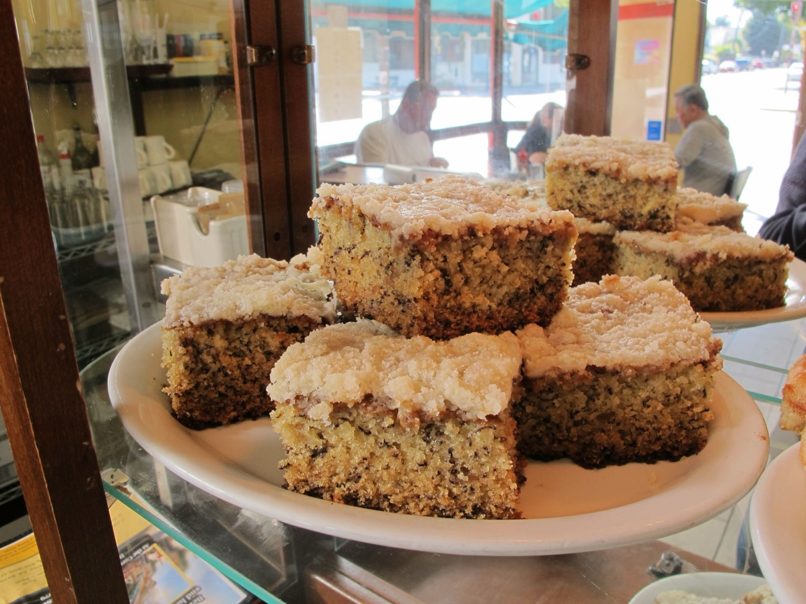 Squares of house-baked coffee cake in the pastry case